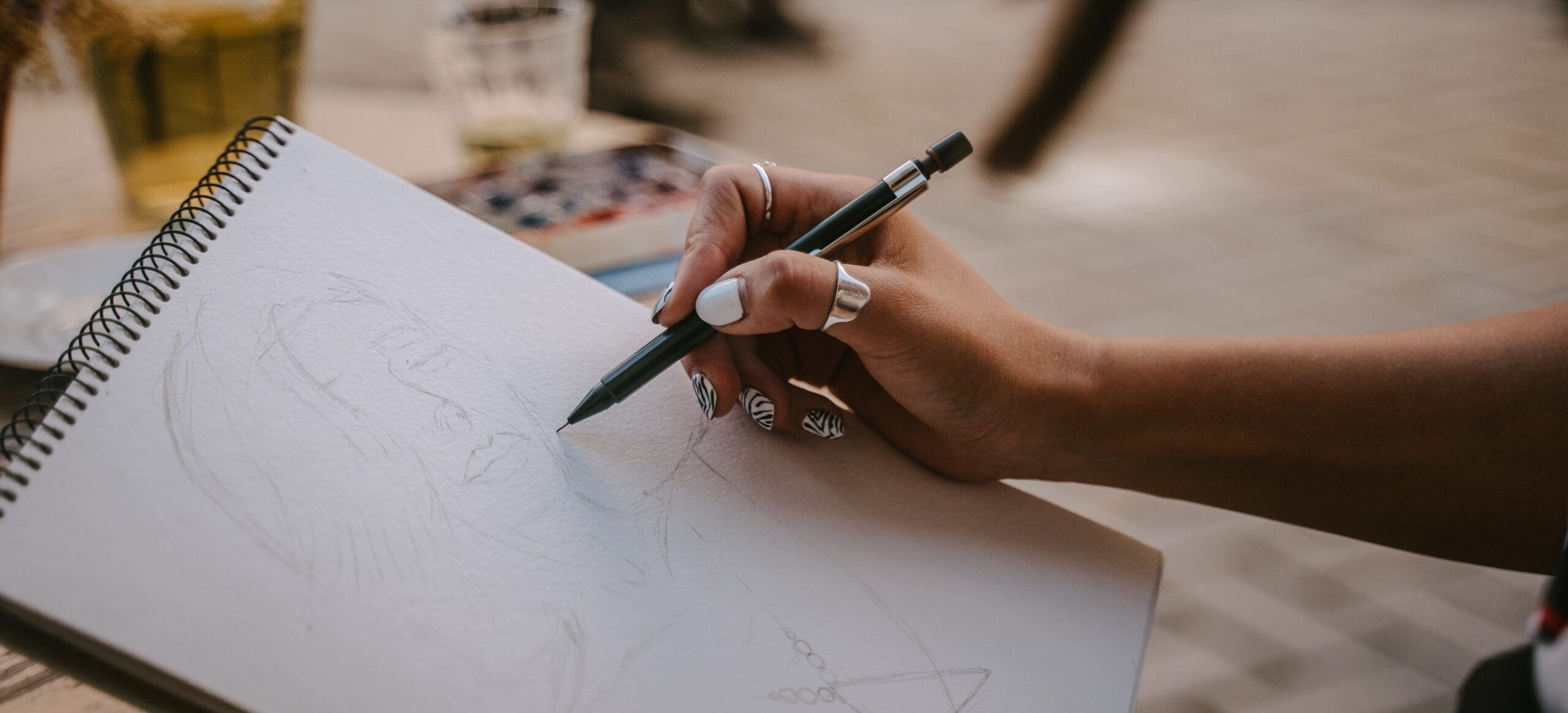 A woman sketches a self-portrait