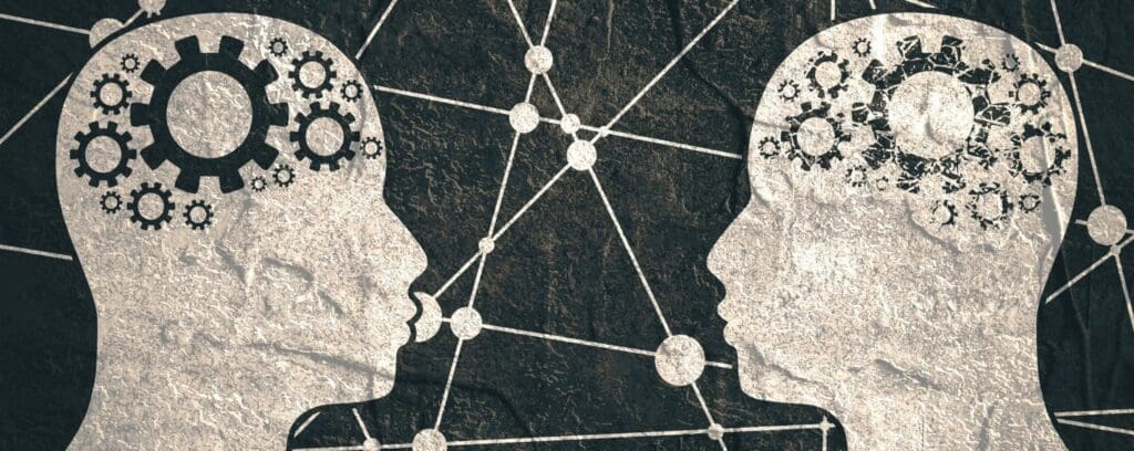 Illustration of two head outlines full of gears facing each other
